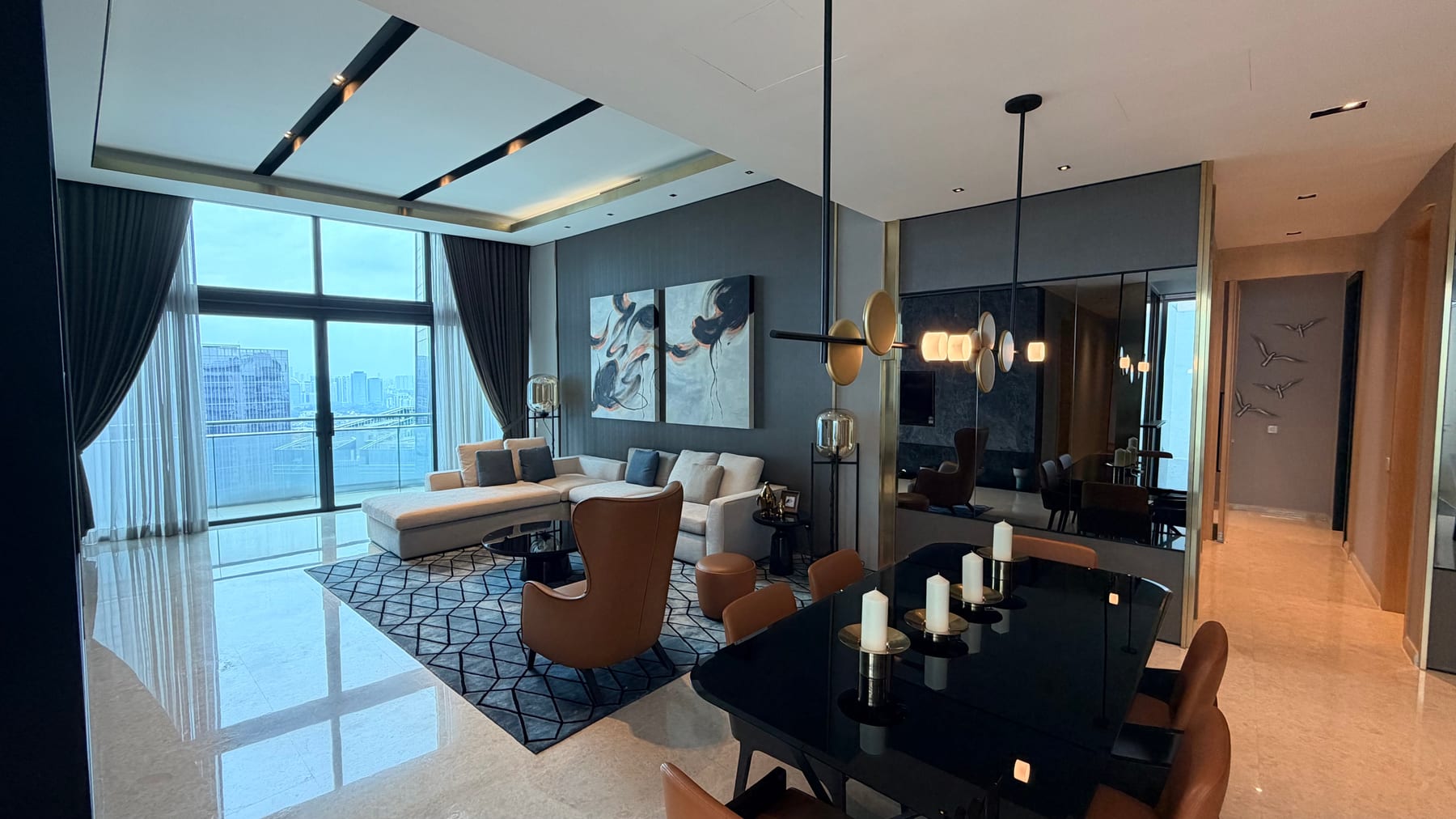 Living and dining interior with tall windows at DC Residensi; project image